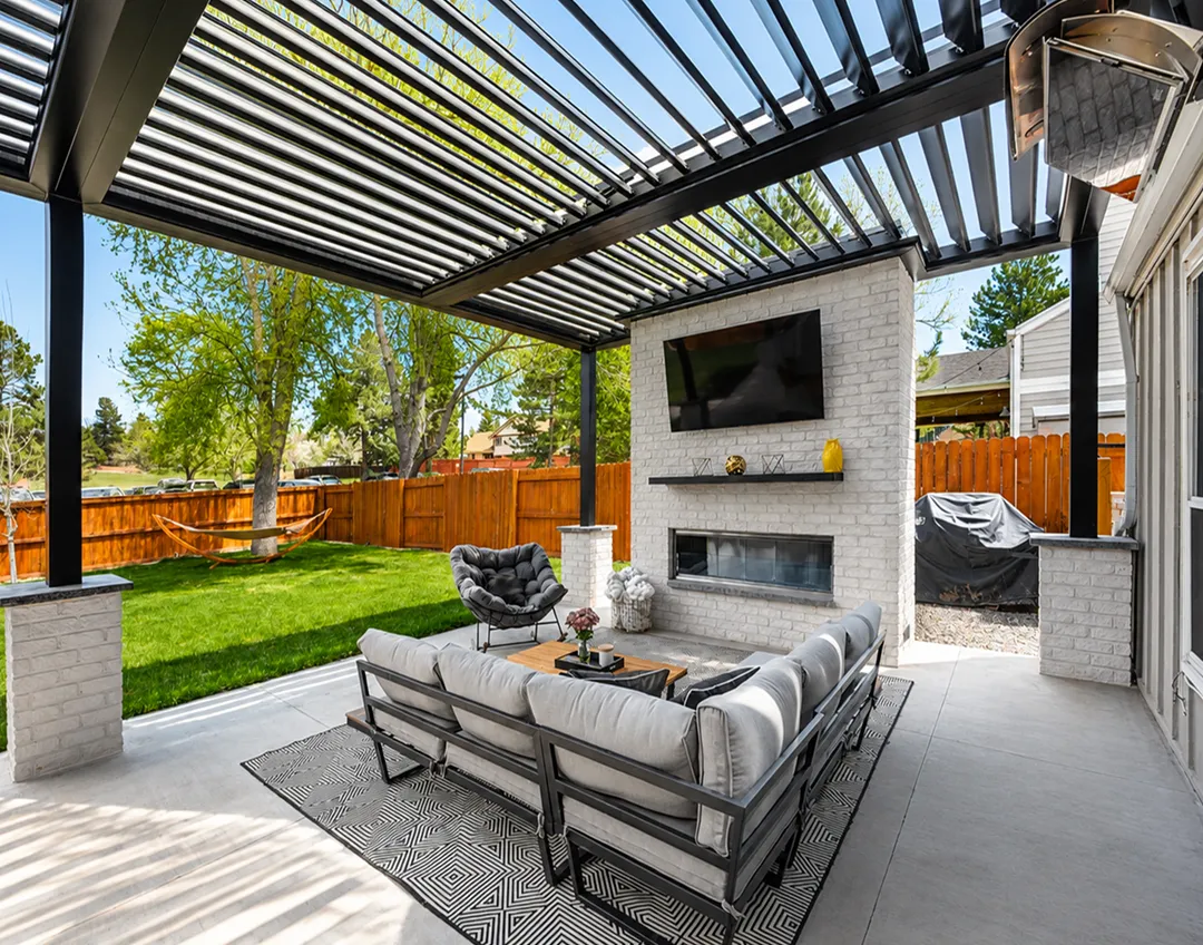 Louvered aluminum pergola installed with custom deck in Colorado by Decks by Caio