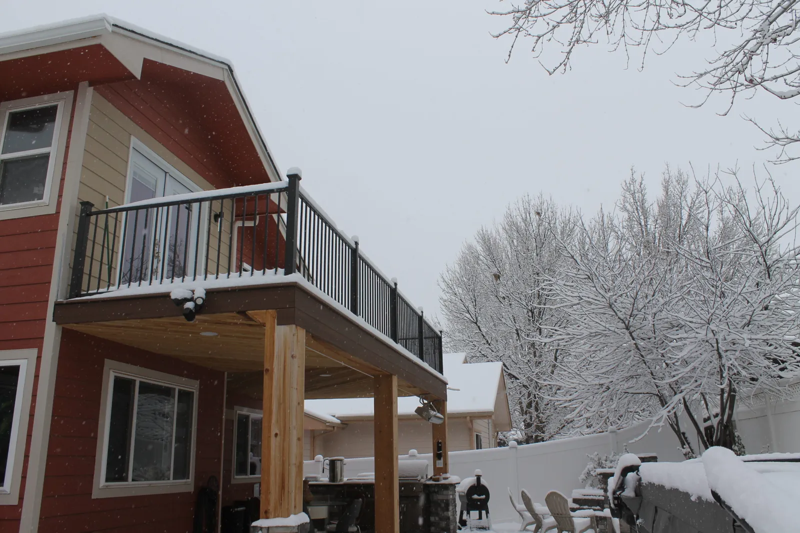 Elevated residential deck in Colorado covered with snow during winter freeze conditions